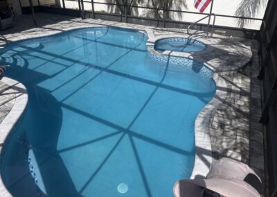 Happy customer enjoying their newly renovated pool by Planet Pool Renovations in Orlando, FL