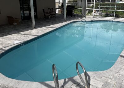 Completed pool renovation with new paver deck and resurfaced pool by Planet Pool Renovations in Orlando, FL