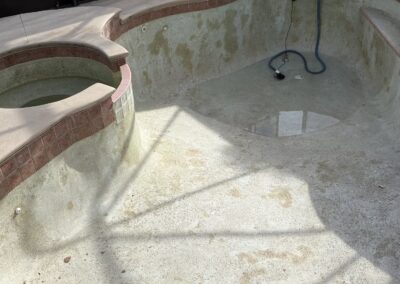 Drained pool shell prepared for resurfacing by Planet Pool Renovations in Orlando, FL